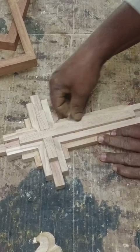 Artisan assembling a wooden wall panel in the INOUTSPACE workshop